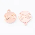 Macro view of rose gold round charms with relief pinky promise gesture and closed rings - Rose Gold