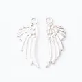 Macro detail of silver angel wing charms showing fine feather texture and metal loops - Bright Silver