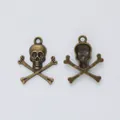 Macro view of vintage bronze skull and crossbones pendants for DIY jewelry making - Antique Bronze