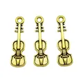 Detailed view of three vintage bronze violin charms with antique texture for DIY jewelry - Violin / Antique Gold