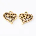 Macro view of vintage heart charms with hollow patterns for DIY jewelry making - Antique Gold