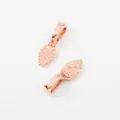 Detail of rose gold alloy pendant charms featuring hammered texture and leaf shape design - Rose Gold