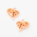Close-up of two rose gold heart-shaped hollow metal charms for DIY jewelry making - Rose Gold