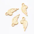 Macro shot of four golden wing pendants showing detailed feather texture and rings - Gold