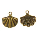 Detailed macro view of vintage bronze alloy shell charms with intricate radial textures - Antique Bronze