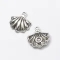 Detailed close-up of shell-shaped silver alloy charms with grooved texture for DIY jewelry - Antique Silver
