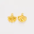 Detail of two gold scallop shell charms with fine radial texture and pearl mountings - Gold