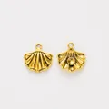 Vintage golden shell-shaped alloy pendants with radial texture and circular inlay base - Antique Gold