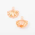 Macro detail of rose gold shell pendants with wavy texture and mounting rings for DIY jewelry - Rose Gold