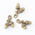 Three vintage bronze double acorn alloy pendants for DIY jewelry making on white background - Antique Bronze