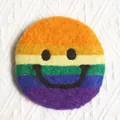 Rainbow striped wool felt coaster with a simple black smiley face and plush texture - Multicolor