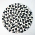 Handmade round wool felt ball cushion in neutral black, white, grey and brown colors - Round / Black White Grey
