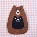 Cute brown bear wool felt coaster with smiling bear detail on pink checkered background - Hold Bear Style