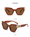 Détail de lunettes de soleil œil-de-chat marron avec décorations en métal doré grec - Monture Thé Verres Thé