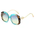 Ovale Mode-Sonnenbrille mit gewelltem zweifarbigem Rahmen und herzförmigen Metalldetails - Sonnenbrille (C4) / Blauer Rahmen Grau-Tee Gläser