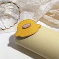 Detailed view of yellow cartoon bird hair tie with fine stitching and soft texture - Duck Hair Clip
