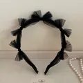 Close-up of black lace mesh headband with elegant butterfly bows and pearl accents - Black Bow Mesh