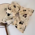 Detail of panda and bamboo ink print on beige fabric scrunchie with traditional fan - Panda Bamboo Scrunchie