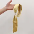 Close-up of a yellow satin headband with long flowing ribbons and smooth silk texture - Light Yellow
