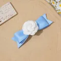 Détail de la pince à cheveux nœud en satin bleu clair avec fleur de camélia blanche - Camélia bleu