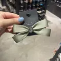 Elegant sage green satin bow hair clip with a sparkling heart crystal detail - Cyan Bowknot