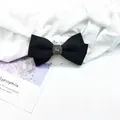 Detail of black wool bow hair clip featuring a vintage rhinestone center on a display card - Velvet-Look Material / Black