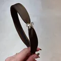 Detalle de diadema de satén marrón con lazo de cristal brillante y forro antideslizante - Estilo Lazo Strass (Café) / Marrón