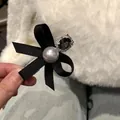 Elegant black ribbon bow hair clip featuring a grey pearl and sparkling dark rhinestone detail - Black