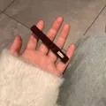 Brown teddy plush hair clip with Lovedays tag shown in hand for daily wear - Dark Coffee With Metal Label