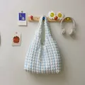 Blue and white striped seersucker bubble tote bag hanging with stylish accessories - White with Blue