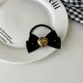 Close-up of velvet bow hair scrunchie with handmade heart metal charm and sparkles - Hair Tie / Black