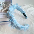Blue and white tweed headband with fringe texture and handmade label on plush background - Sky Blue Plaid