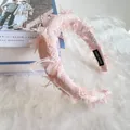 Detailed view of pink tweed headband with hand made label and frayed edge texture - Pink Gingham