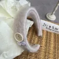 Close-up of plush mohair headband featuring vintage buttons and soft knit texture - Pink Heart Button