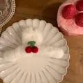 Detail of plush white hair claw clip with cute red cherry decor on ceramic plate - Large Cherry Hair Claw
