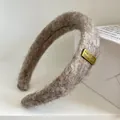 Detail of grey velvet headband showing the handmade metal label and soft plush texture - Khaki Smiley Letter / Khaki
