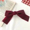 Close-up of a vintage dark red velvet bow hair clip on a retro book background - Burgundy Large Style