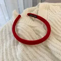 Detail of red corduroy headband with handmade label on soft white knit background - Red Stripe
