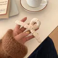 Pince à cheveux en velours côtelé beige crème avec un design minimaliste torsadé - Abricot