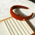 Maillard caramel velvet headband with high-crown design and golden brand tag - Caramel Padded Metal Tag Style