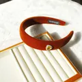 Maillard orange velvet padded headband with rhinestone heart jewel on white stand - Caramel Sparkling Heart Rhinestone Style