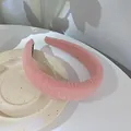 Detailed view of a soft pink bubble-textured wide headband on a ceramic tray - Pink Plaid