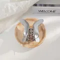 Elegant silver metal butterfly hair claw clip for women on marble base tray - Silver