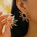 Exaggerated golden sunburst hoop earrings with hollow center in a vintage designer style - Sunburst Radial Style (2687) / Gold