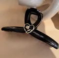 Elegant black glossy hair claw clip with vintage gold rose heart emblem in twisted design - Black Rose Heart