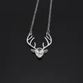 Macro shot of silver deer antler necklace pendant with crystal drop and rhinestone accents - Silver + White