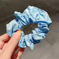 French vintage style sky blue plush scrunchie with soft fabric texture and elegant folds - Blue