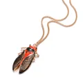 Détail d'un collier pendentif cigale vintage avec des ailes émaillées rouges et noires - Or