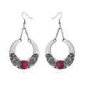 Detail of bohemian silver alloy earrings with vintage engraving and red gemstones - Red