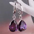 Detail of purple teardrop crystal earrings with faceted stone and silver lever-back hooks - Purple